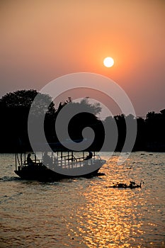 Silhouette of a Thai passenger ship on sunset