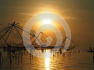 Silhouette thai traditional fishing equipment trap build with ba photo