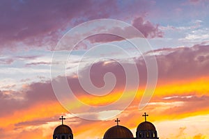 Three cross on a church roof against beautiful evening sky