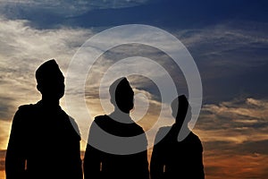 Silhouette of a three man parade.