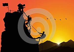 Silhouette of three men climbing mountain by helping each other on sunrise background, successful teamwork concept