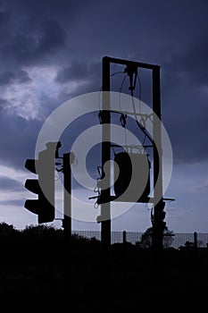 Silhouette of Three phase 11KV overhead powerline with transformer on pole and traffic lights