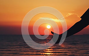 Silhouette thumbs up hand sign with sunrise beach