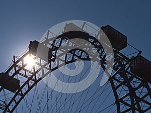 Silhouette of the top of a famous Ferris wheel (Riesenrad) in amusement park Wurstelprater in Vienna, Austria.