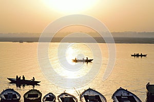 Silhouette tourist boats at Ganges river in Varanasi, India at sunrise