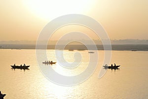 Silhouette tourist boats at Ganges river in Varanasi, India at sunrise