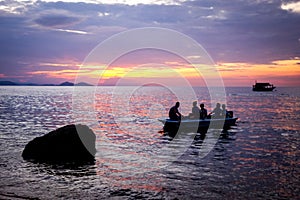 Silhouette of tourists in a boat at sunset in Komodo NP