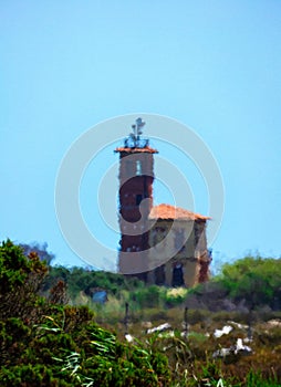 Silhouette of a tower house, blurred by the midday heat