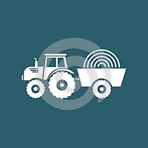 Silhouette of a tractor with a cart with hay