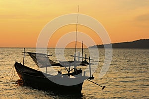 Silhouette of traditional fishing boat at sunrise, Koh Rong island, Cambodia