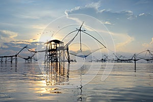 Silhouette traditional fishing method using a bamboo square dip