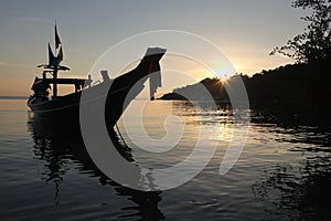 Silhouette of a traditional thai fishing boat moored close to the beach, Chalok Bann Kao, Koh Tao, Thailand