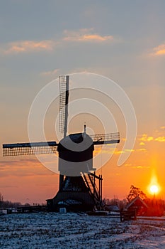 Silhouette of traditional windmill at dawn, Kinderdijk, Netherlands