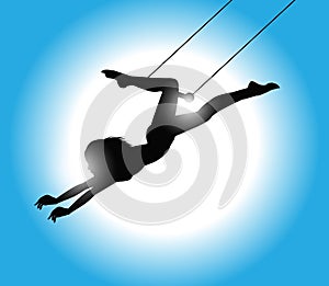 Silhouette of trapeze artist