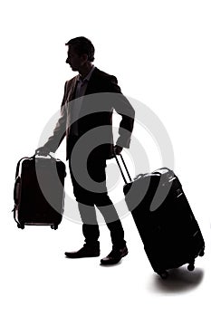 Silhouette of Traveling Businessman Checking in Luggage