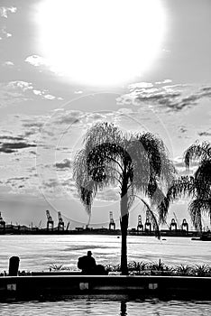 Silhouette of a Traveller Sitting by the Ocean in Pier Mauá - Rio de Janeiro, Brazil