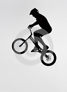 silhouette of trial biker jumping on bicycle