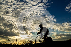 Silhouette of a triathlete in sunset photo