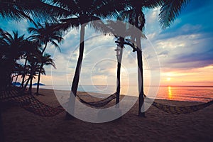 Silhouette of tropical beach during sunset twilight.