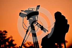 Silhouette of a TV cameraman