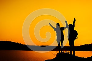 Silhouette two girls join hands to celebrate the success.