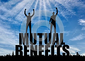 Silhouette of two happy men with raised arms standing on the word mutual benefit