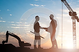 Silhouette Of Two Male Architect Shaking Hands