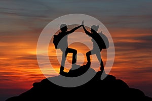 The Silhouette of two man with success gesture