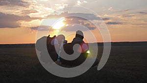 The Silhouette of two man on the top of mountain with Backpacks and other Gear expressing Energy and Happiness. Two