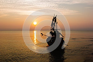 Silhouette of two people on a fishing boat.