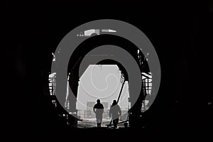 The silhouette of two people in a high-speed railway tunnel under construction