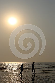 Silhouette of two person on beach photo