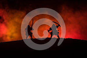 Silhouette of two samurais in duel. Picture with two samurais and sunset sky