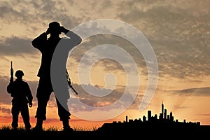Silhouette of two soldiers with guns