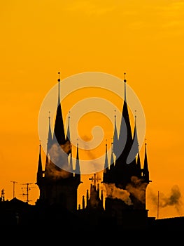 Silhouette of two towers of Church of Our Lady before Tyn in morning Prague, Czech Republic. Contrast black controur and