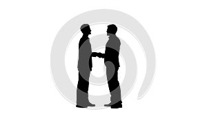 Silhouette Two young and handsome business partners in suits meet and shake hands, full size video