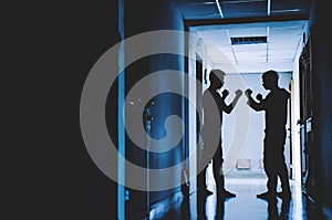 Silhouette of two young men angry conflict fighting with each other in  the old condo