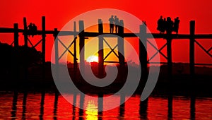 Silhouette of the U Bein bridge over the Taungthaman Lake at sunset in Myanmar
