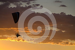 Silhouette of an ultralight flying