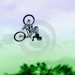 Silhouette of unidentified young man performs stunts on background of vivid sky. Extrem Sport and risk