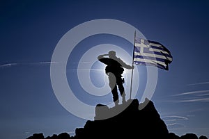 Silhouette of an unrecognizable soldier with the Greek flag