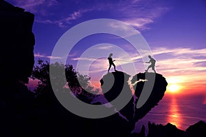 Silhouette Valentine background concept, Couples pulling the rope on broken heart-shaped stone.