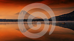 Silhouette view of fishermen on boats with mist and twilight sky during dawn at Shoji lake in Yamanashi, Japan. Landscape with