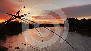 Silhouette view with lake fisheries in evening sky