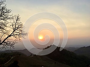 Silhouette view on mountain, sunset light and blue sky