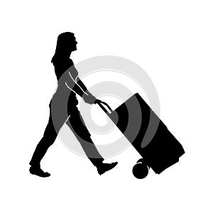 Silhouette of a warehouse worker female pulling a lori or trolley wheels full of boxes.