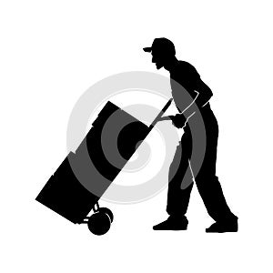 Silhouette of a warehouse worker male pulling a lori or trolley wheels full of boxes.