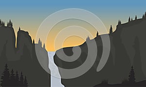 Silhouette of waterfall at sunset