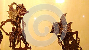 Silhouette Wayang kulit or puppet art from Java, Indonesia with orange light background