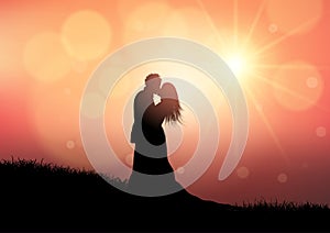 Silhouette of a wedding couple on sunset background